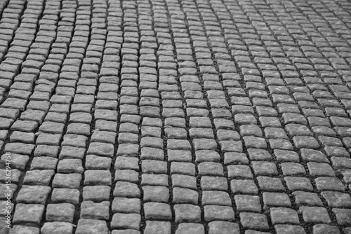 Fototapeta Naklejka Na Ścianę i Meble -  Old cobblestone sidewalk, pavement as background, perspective view. Stone Pavement or Granite Cobblestone Road Top View. Mosaic Brick Cobblestone Floor with Tiles and Small Stones
