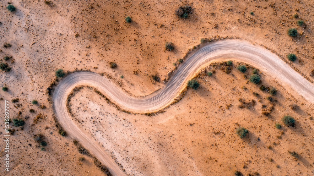 Winding dirt road through arid landscape Winding dirt road through arid landscape