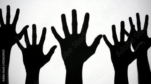 Silhouetted hands raised against bright background, creating sense of unity and participation with black silhouettes, highlighting dramatic
