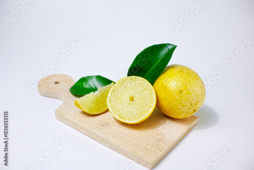 lemon with slice and green leaves isolated on white background. clipping path