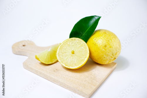 lemon with slice and green leaves isolated on white background. clipping path