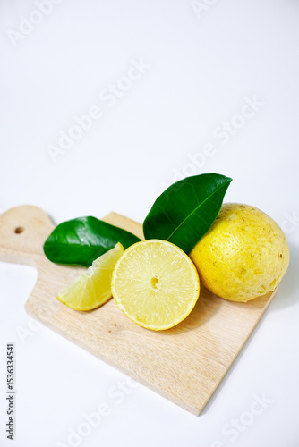 lemon with slice and green leaves isolated on white background. clipping path