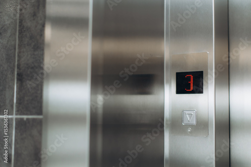 Modern Elevator Panel Displaying Floor Number Three with Downward Button
