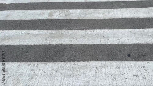Wallpaper Mural Urban crosswalk texture close-up with worn white stripes and rough asphalt detail
 Torontodigital.ca