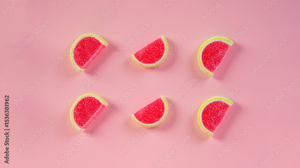 Fototapeta premium Fruit jelly mixed with sugar on pink background