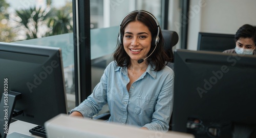 young latina woman at customer support station wearing headset friendly