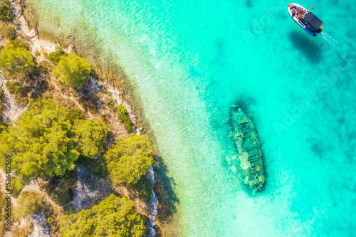 Aerial photograph of the sunken ship near Solta Island, Croatia, now a popular tourist attraction, resting in shallow turquoise waters along the Adriatic coast and surrounded by nature photo
