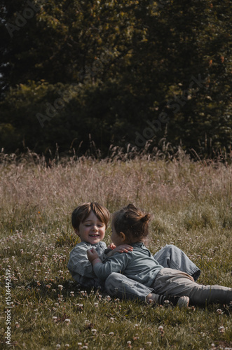 Portrait de deux enfants qui chahutent dans la nature