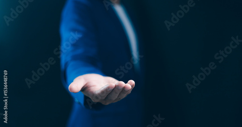 Fototapeta Naklejka Na Ścianę i Meble -  Businessman extending an open hand, offering or receiving something, concepts of giving, taking, collaboration, partnership, and customer service. Ideal for trust, charity, or presentation visuals