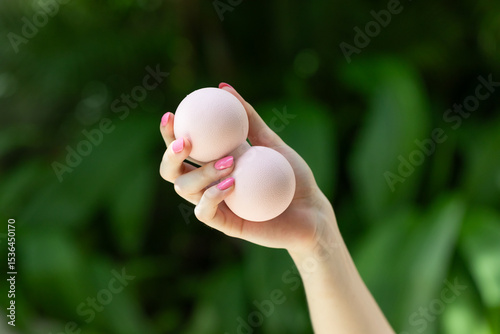 girl holding double massage ball in her hands. Ball massager for yoga pilates or stretching and fascia pain. Sports and massage