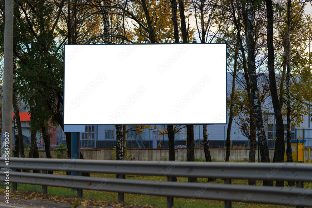 Fototapeta premium Advertising billboard along the road in the city on a autumn sunny evening. Background for design. 