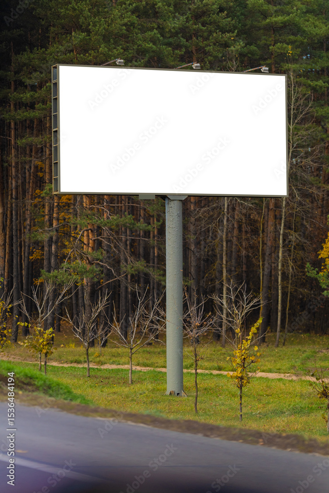 Fototapeta premium White billboard along the highway. Background for design and advertising.