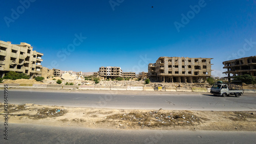 Abandoned Buildings and Deserted Road Under Clear Sky In Damascus Jobar district, Syria