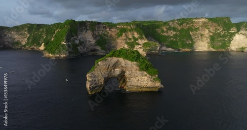 Bali Nusa Penida Banah Cliff Point rock arch aerial drone sea coast sunset