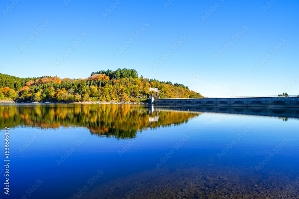 Obraz premium View of the Oleftalsperre Dam and the surrounding landscape. Nature at the lake near the Eifel National Park near Hellenthal in the Hohes Venn-Eifel Nature Park. 