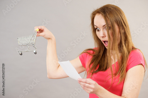 Woman with bill and shopping cart