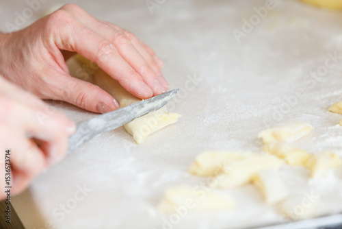Hands making noodles