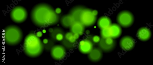 Green blurred bokeh particles with varying size and opacity on black background. Abstract design element for festive or sci-fi scenes.