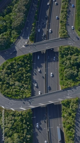Aerial view of cars and trucks driving on a highway interchange in Auckland, New Zealand. The clip shows the infrastructure and transportation system. Ellerslie.