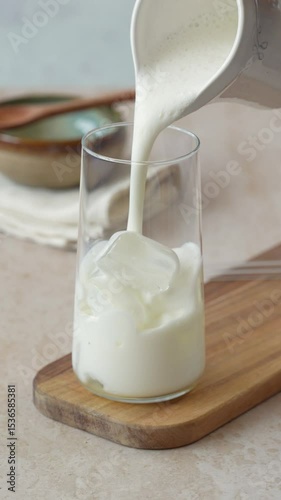 Pouring milk over ice for matcha latte or ice latte 