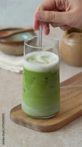 Matcha drink, matcha latte with ice in tall glass 