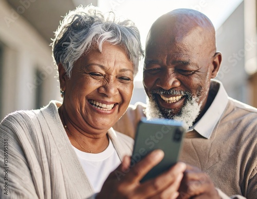 Elderly Man and Woman Exploring Technology. Laughing and looking at mobile phone together