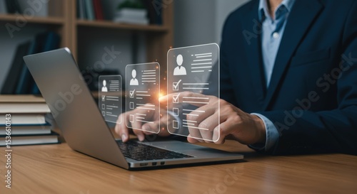 Businessman using laptop for online recruitment and candidate selection with digital checklist