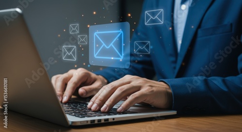 Person types on a laptop with email icons floating above the keyboard