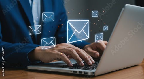 Person types on a laptop surrounded by email icons representing digital communication and online business