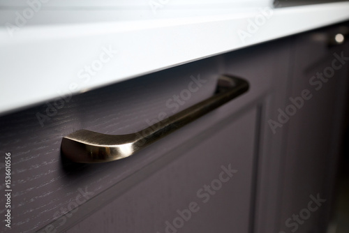 Handle brass classic of cabinet doors, kitchen bathroom cabinet Silk grey solid ash wood painted cupboard cabinet door fitting selective focus close up.