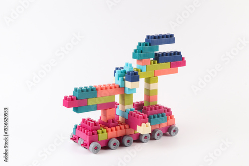 Plastic building blocks form vehicle on white background.