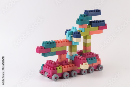 Plastic building blocks form vehicle on white background.