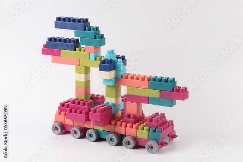 Plastic building blocks form vehicle on white background.