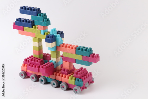 Plastic building blocks form vehicle on white background.