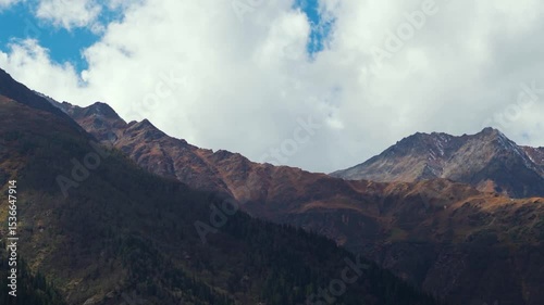 Clouds above the Himalayan mountain range during the summer season as seen from Sangla village in Kinnaur district, Himachal Pradesh, India. Scenic view of mountains in Himachal in summer season.