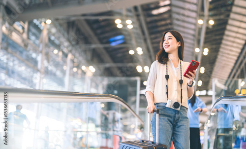Portrait beautiful adult asian woman using smartphone buying travel insurance claim protect at airport terminal transport