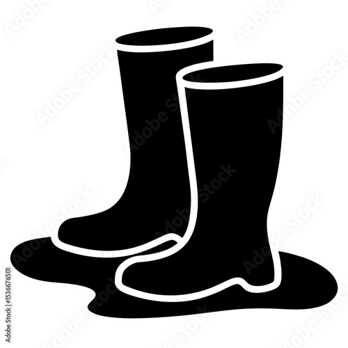Black silhouette of two rubber boots in a puddle of water