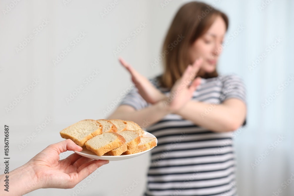 Gluten free diet. Woman refusing from bread indoors, selective focus Gluten free diet. Woman refusing from bread indoors, selective focus