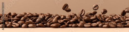 Fresh coffee beans scattered in horizontal arrangement, creating rich and inviting atmosphere