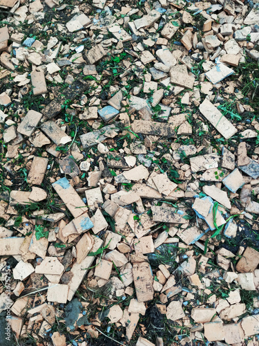 Broken beige plaster stones trimmings on the ground. Background texture.