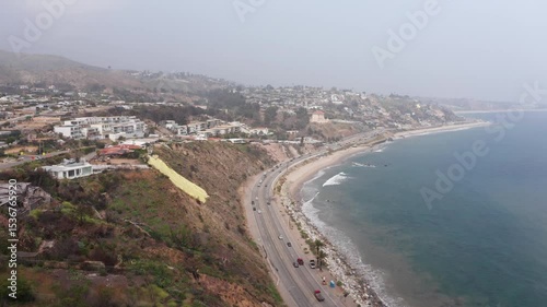 Wallpaper Mural Wide aerial shot flying along the Pacific Coast Highway near the upscale Sunset Mesa neighborhood of Malibu after the Palisades Fire in Los Angeles, California. 4K Torontodigital.ca