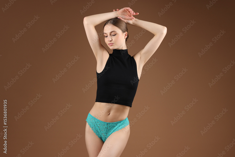 Obraz premium Woman wearing beautiful underwear on brown background