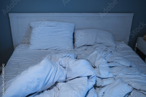 Bed with pillows in a nighttime. Bedroom with moon light.	