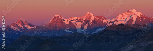 Eiger, Monch and Jungfrau in pink evening light, Switzerland.