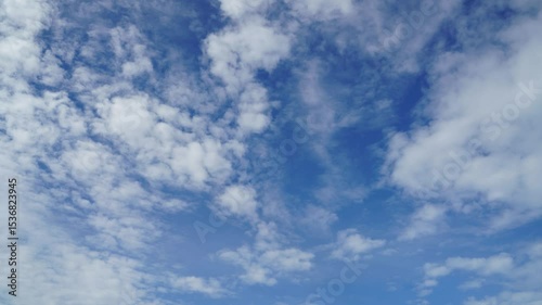 Timelapse of clouds and blue sunny sky,  white clouds over blue sky, Aerial view,  nature, blue sky, white clear weather.