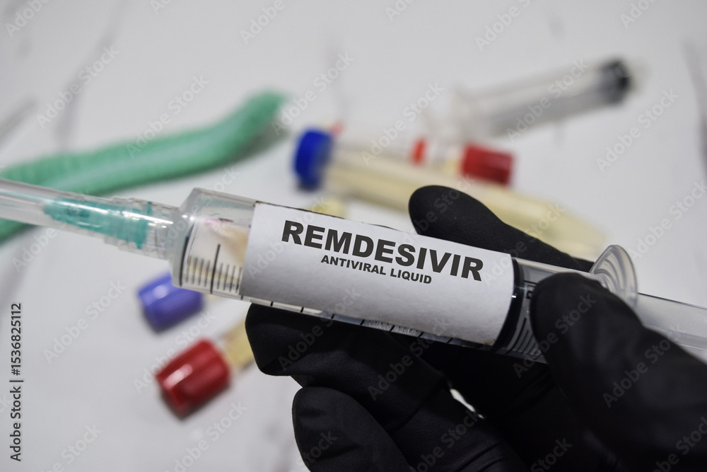Naklejka premium Remdesivir antiviral liquid drug syringe in black gloved hands. Medical concept