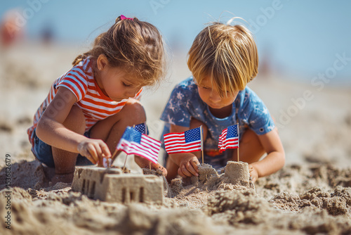 Children building sandcastle on beach with American flags for 4th of July celebration