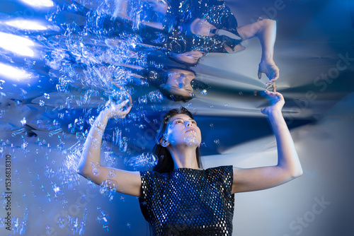 Fotografie Girl in a Stunning Mermaid Outfit Submerged in Shimmering Water Creating an Ench