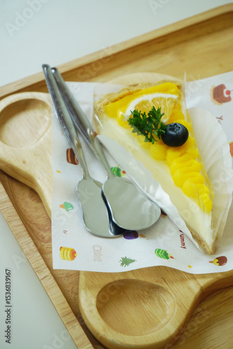 Close up shot of mango fruit cake decorate with orange and blueberry