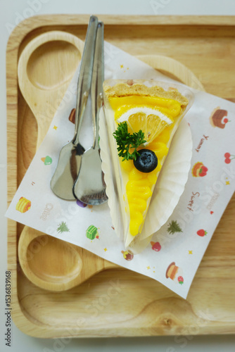 Close up shot of mango fruit cake decorate with orange and blueberry